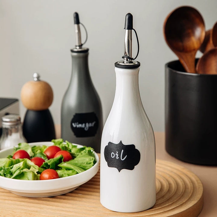 Ceramic oil dispenser bottle with a sealed spout in a wabi-sabi minimalist style.