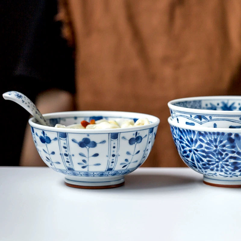 Blue and white floral porcelain bowls set with traditional Chinese design.