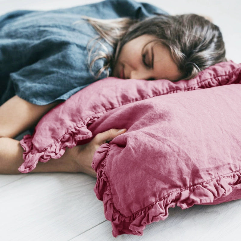 Rustic linen pillowcases with frills in mauve, set of 2, shown with a sleeping person.