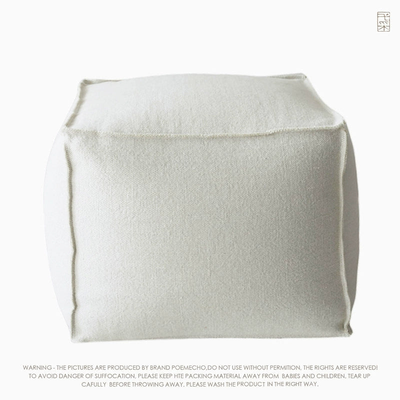 Off-white square knitted pouf ottoman, featuring a simple, modern design.  Durable, comfortable, and versatile.