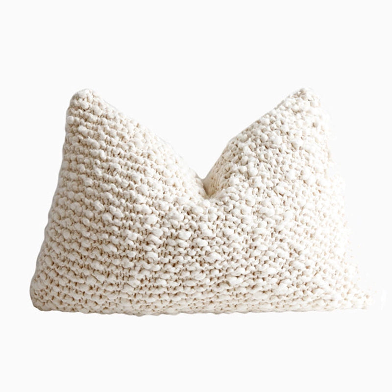 Set of 4 cream knitted throw pillows with textured weave. Cozy decor for sofa.