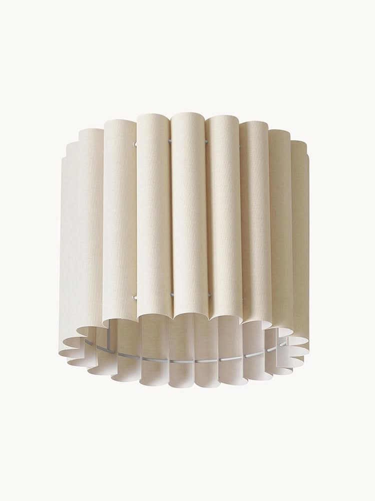Modern pleated fabric pendant light in cream with a modern, cylindrical design for home decor.