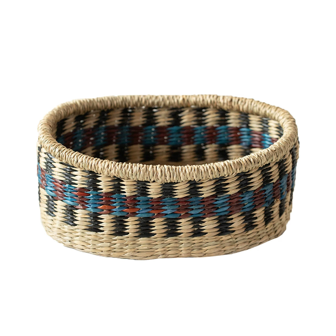 Single boat-shaped seagrass basket featuring a blue, red, and beige woven pattern.