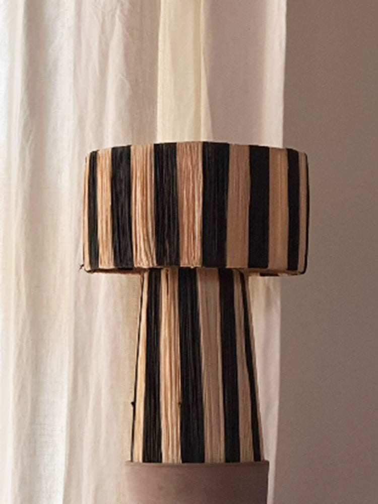 Moroccan Raffia Striped Desk Lamp in black and natural straw with textured finish.