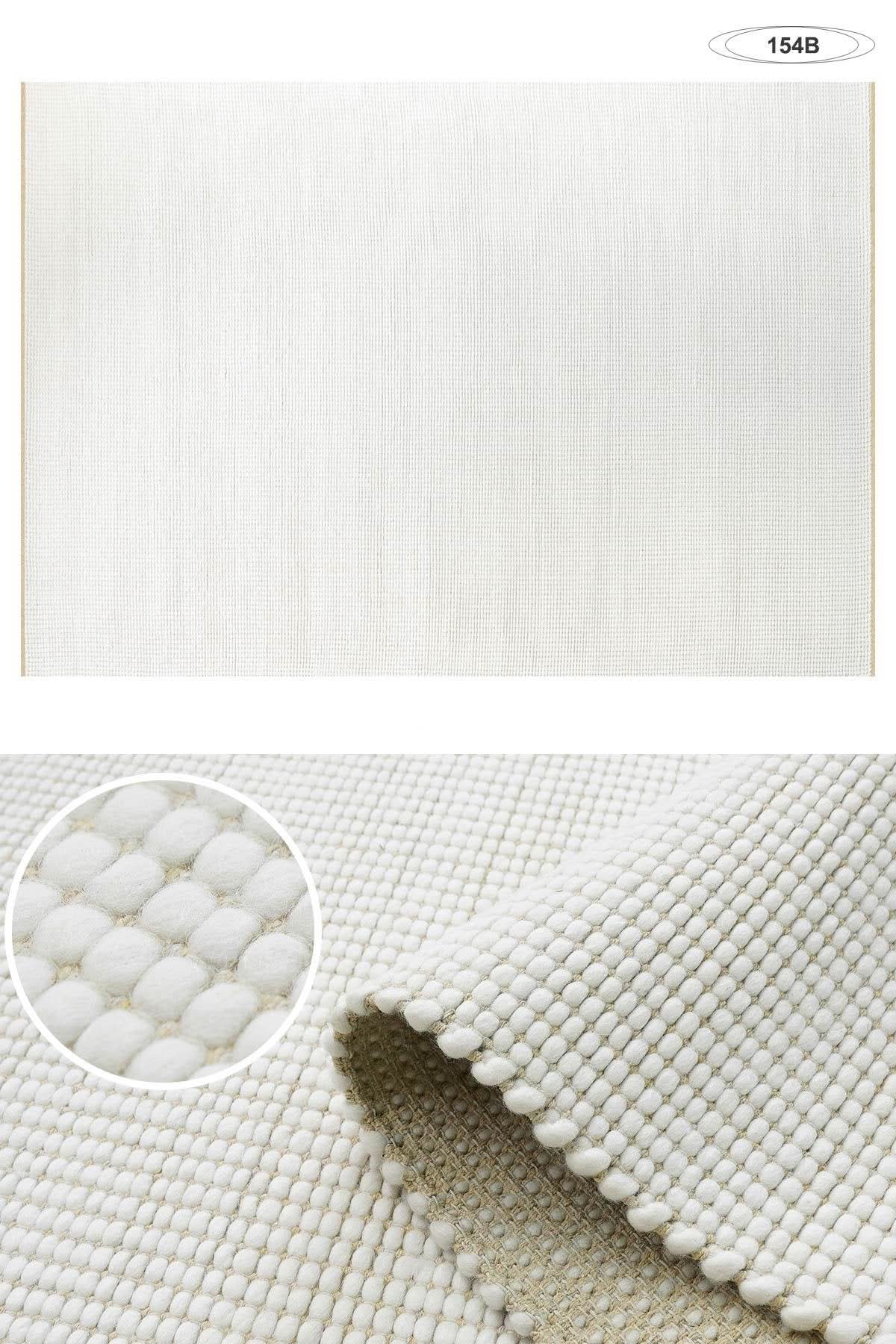 Wool Handwoven Cream Rug with textured, looped pile and woven backing.