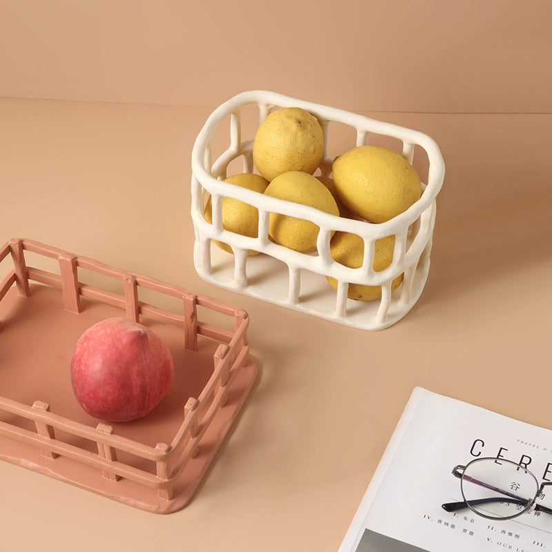 Hand-carved ceramic fruit basket, beige/peach, openwork design, holding lemons.  Durable, decorative storage bowl.