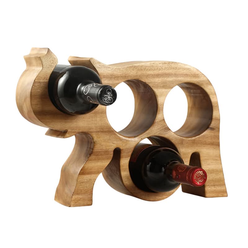Rustic wooden Thai elephant wine rack holding red and black wine bottles.