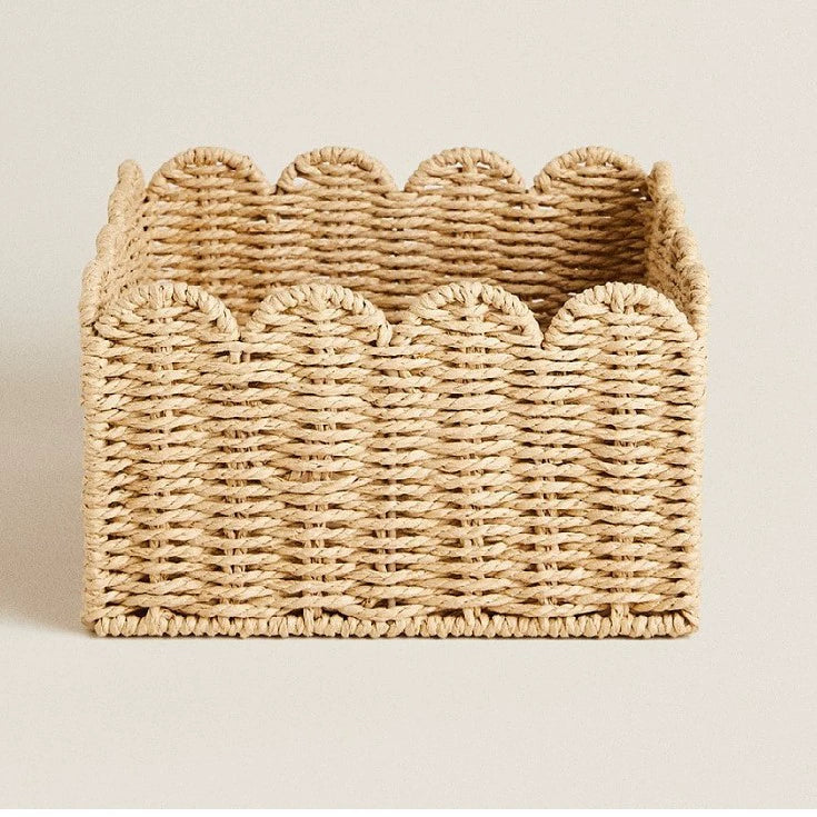 Light beige rattan storage basket with scalloped edges.  Square shape, woven design.