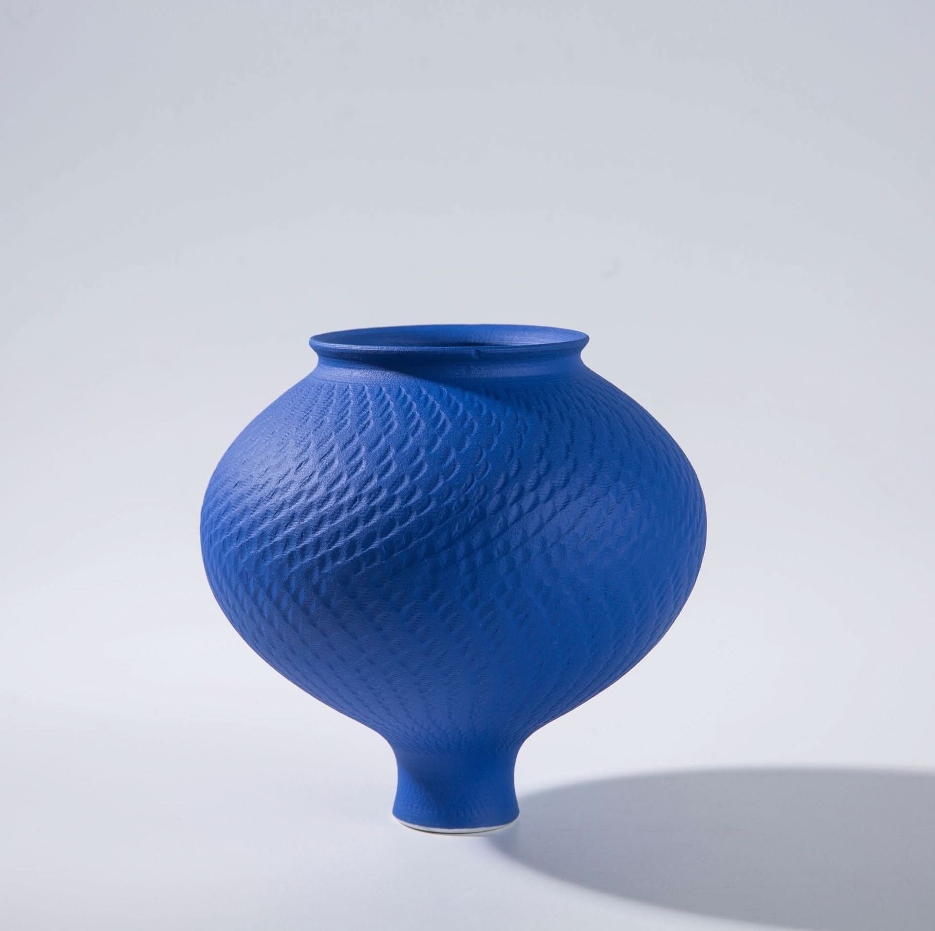 Vibrant blue textured ceramic vase for home decor, with a distinctive diamond pattern.