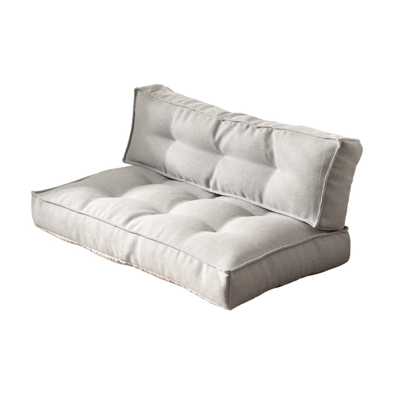 Modern minimalist floor sofa in grey striped fabric with tufted cushions.