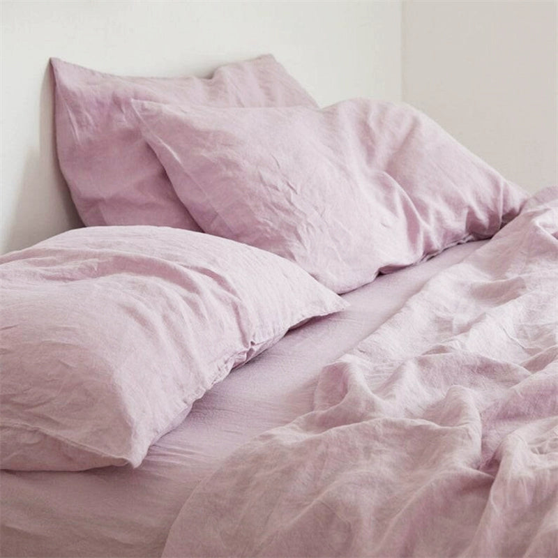 Soft lilac Natural Linen Bedding Set. Comfortable, breathable fabric on a made bed.