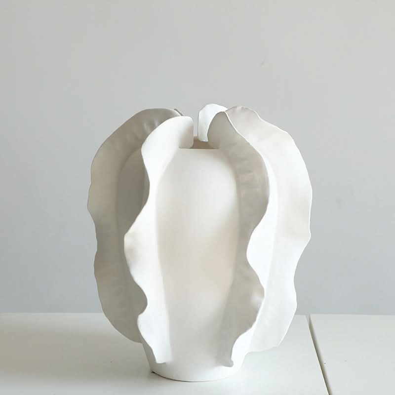 Modern white ruffled ceramic vase set, a striking home decor piece on a white surface.