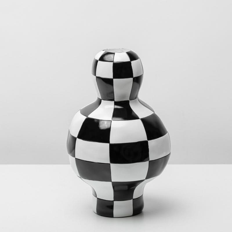 Black and white checkered vase, a bold ceramic home decor piece with a unique checkered pattern.