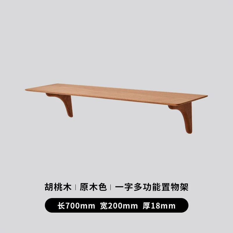 Long walnut wood floating shelf, 700mm, demonstrating extended wall mounting potential.