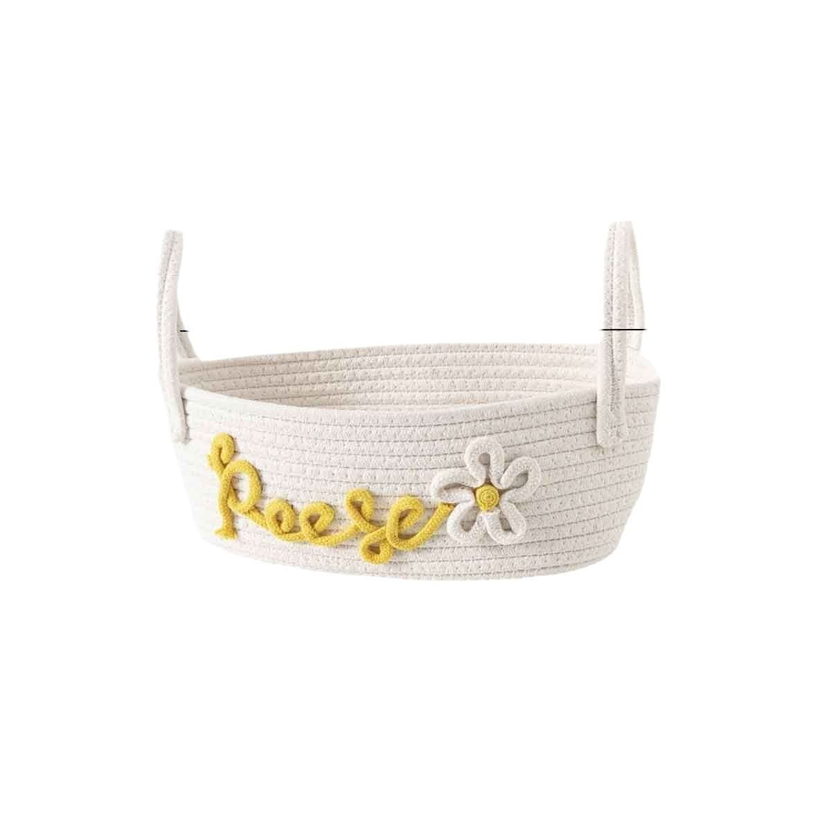 White woven rope storage basket with yellow "Reese" name and daisy detail.