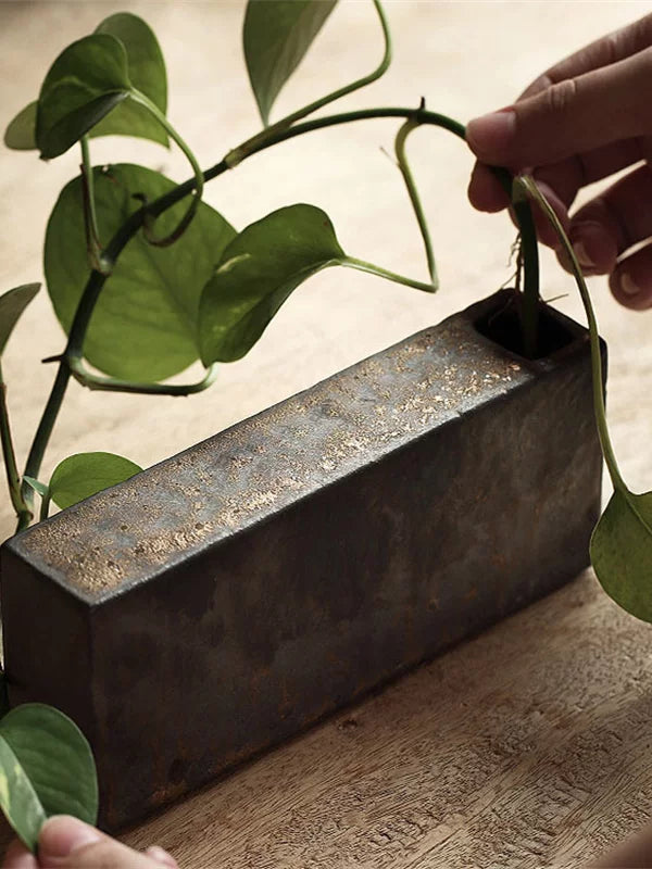 Handmade ceramic vase with a rustic stone texture and metallic micro-light glaze.