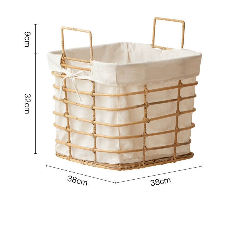 Light beige rattan laundry basket with cream linen liner.  Square shape, metal handles, and a woven design.