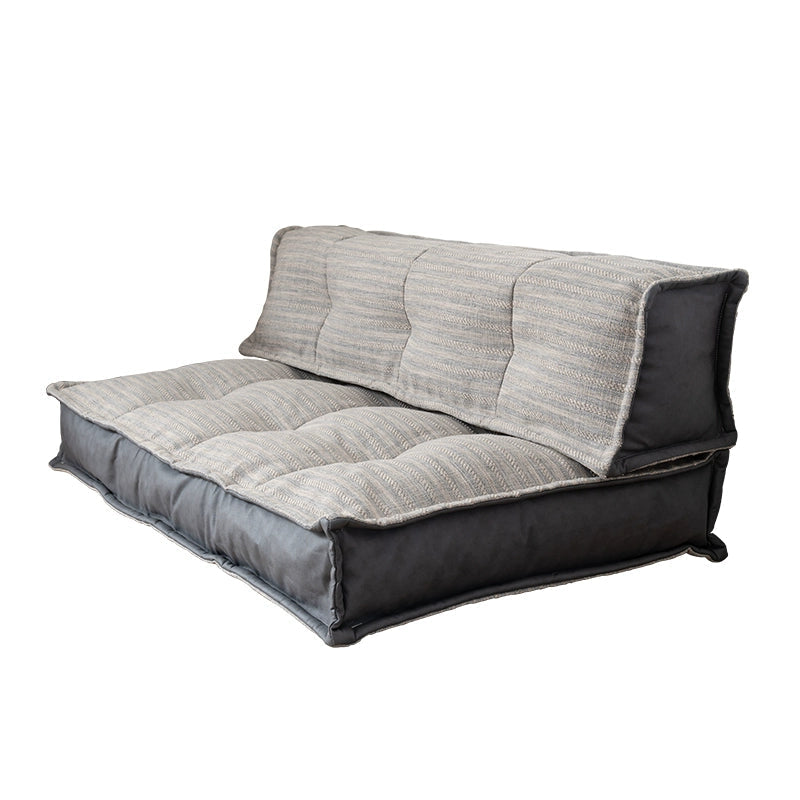 Modern minimalist floor sofa with striped fabric and dark grey base on white background.