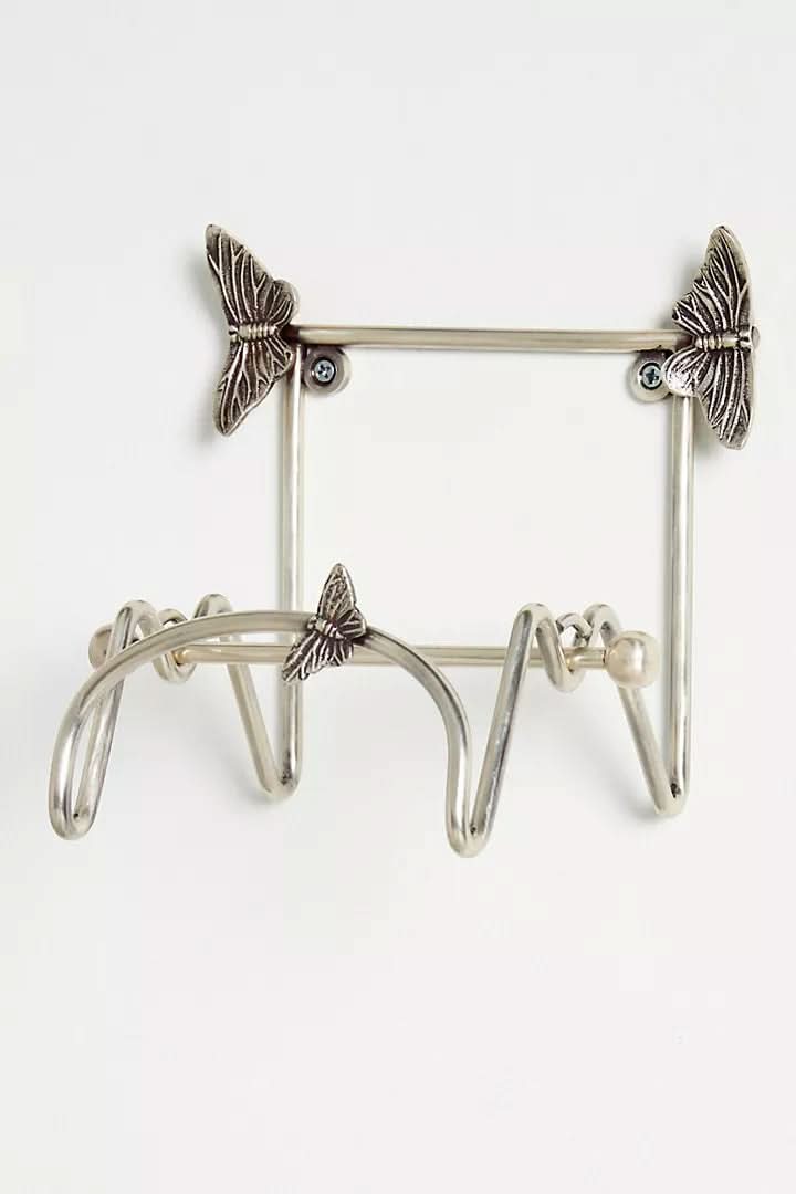 Silver metal butterfly-design wall-mounted bathroom accessories set.