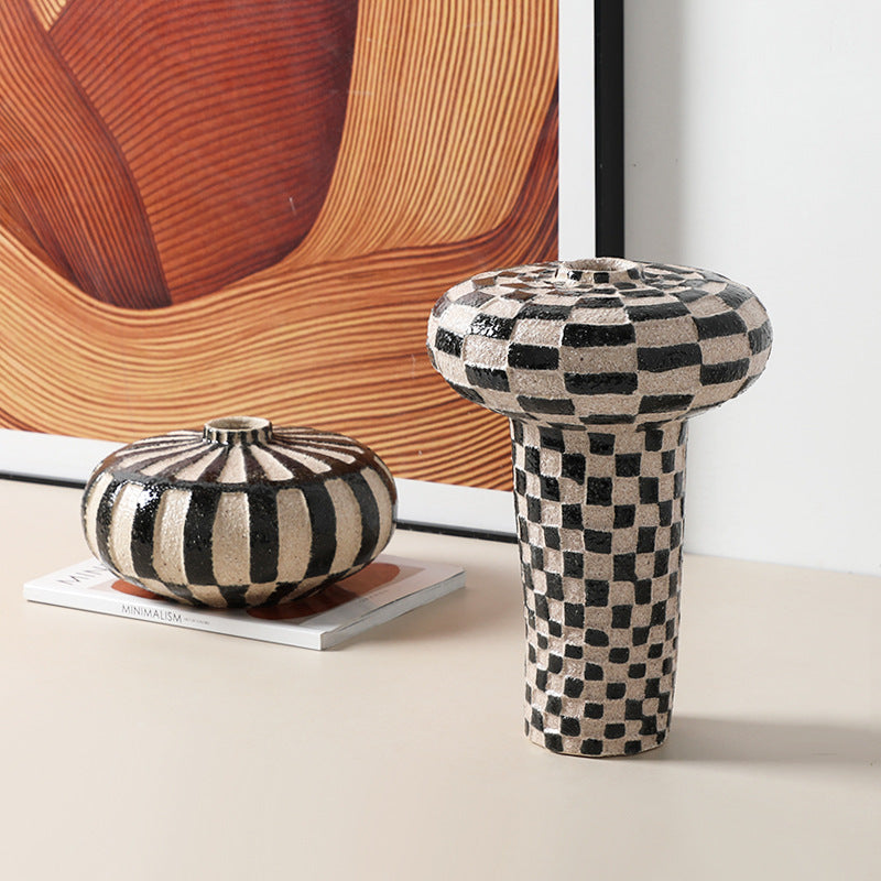 Checkerboard ceramic pedestal with black and beige pattern