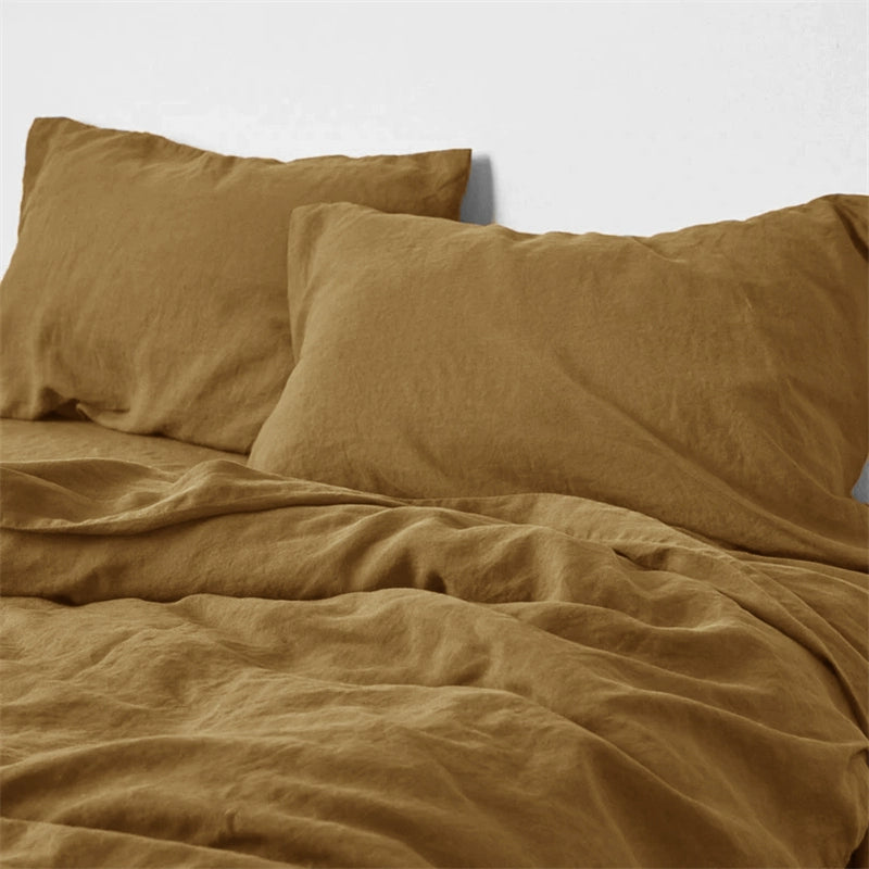 Golden brown natural linen bedding set on a bed. Soft, comfortable, and cozy.
