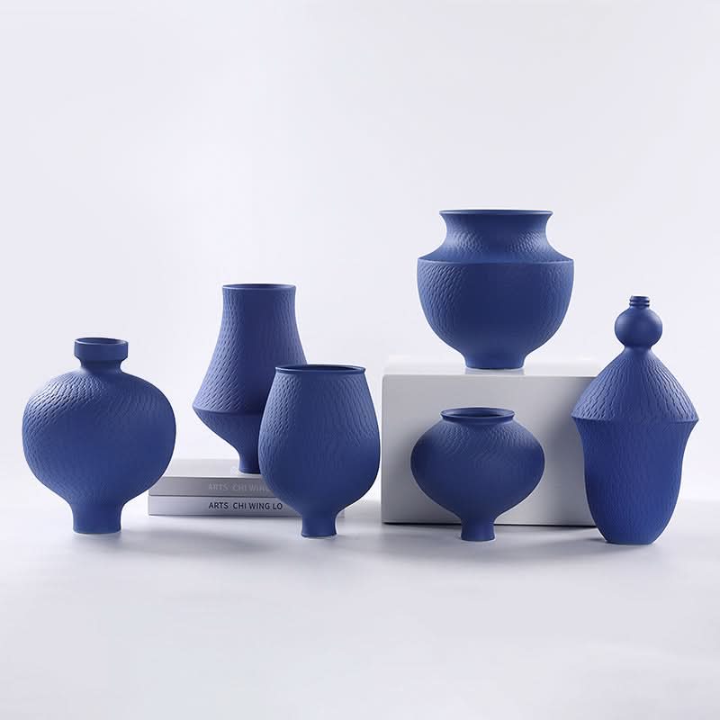Vibrant blue textured vases in assorted shapes, set against a white backdrop. Home Decor.