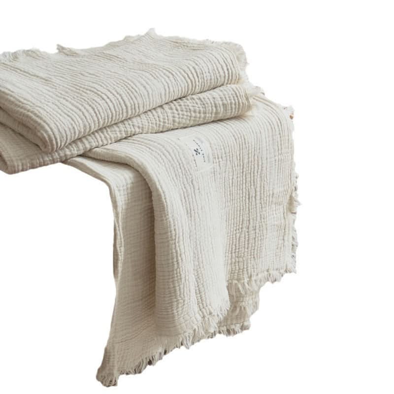 Cozy Textured Cotton Throw Blanket in cream, featuring fringe detail and a soft, crinkled finish.