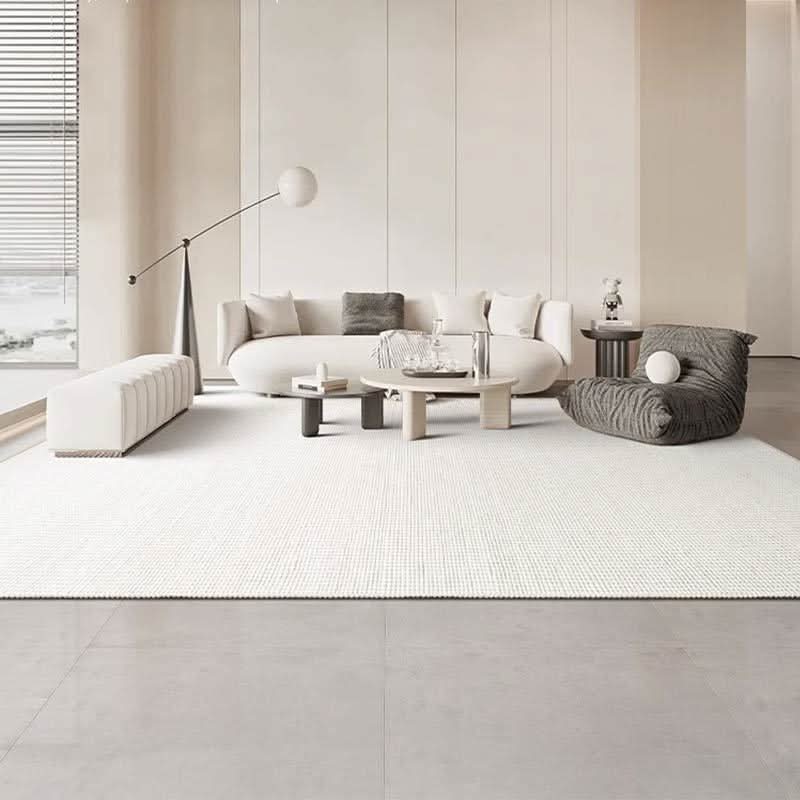 Cream wool handwoven rug in a modern living room with white sofa and minimalist decor.