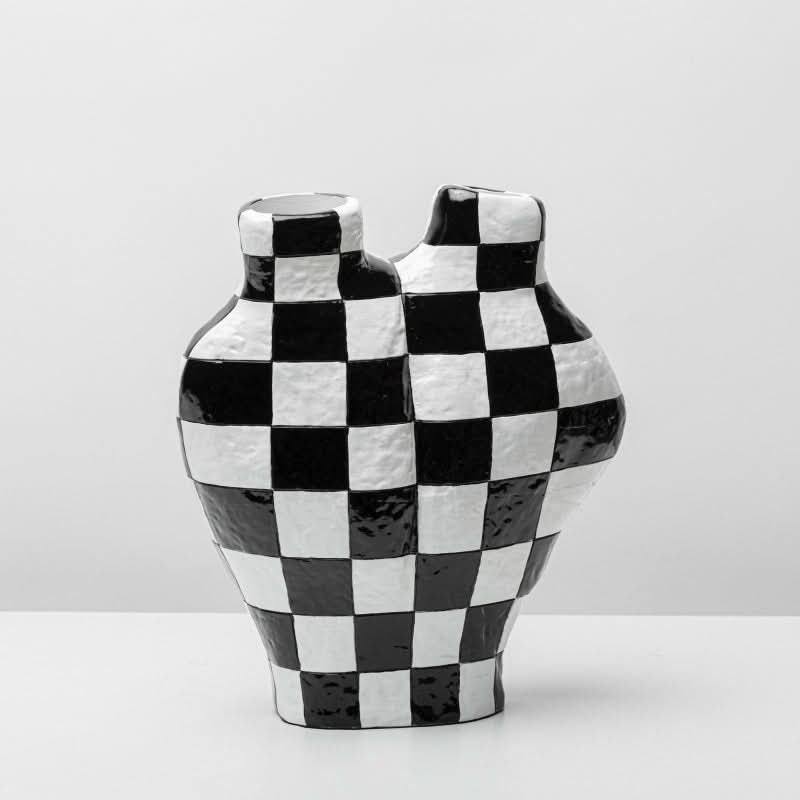 Black and white checkered vase with a textured finish, a unique home decor piece.