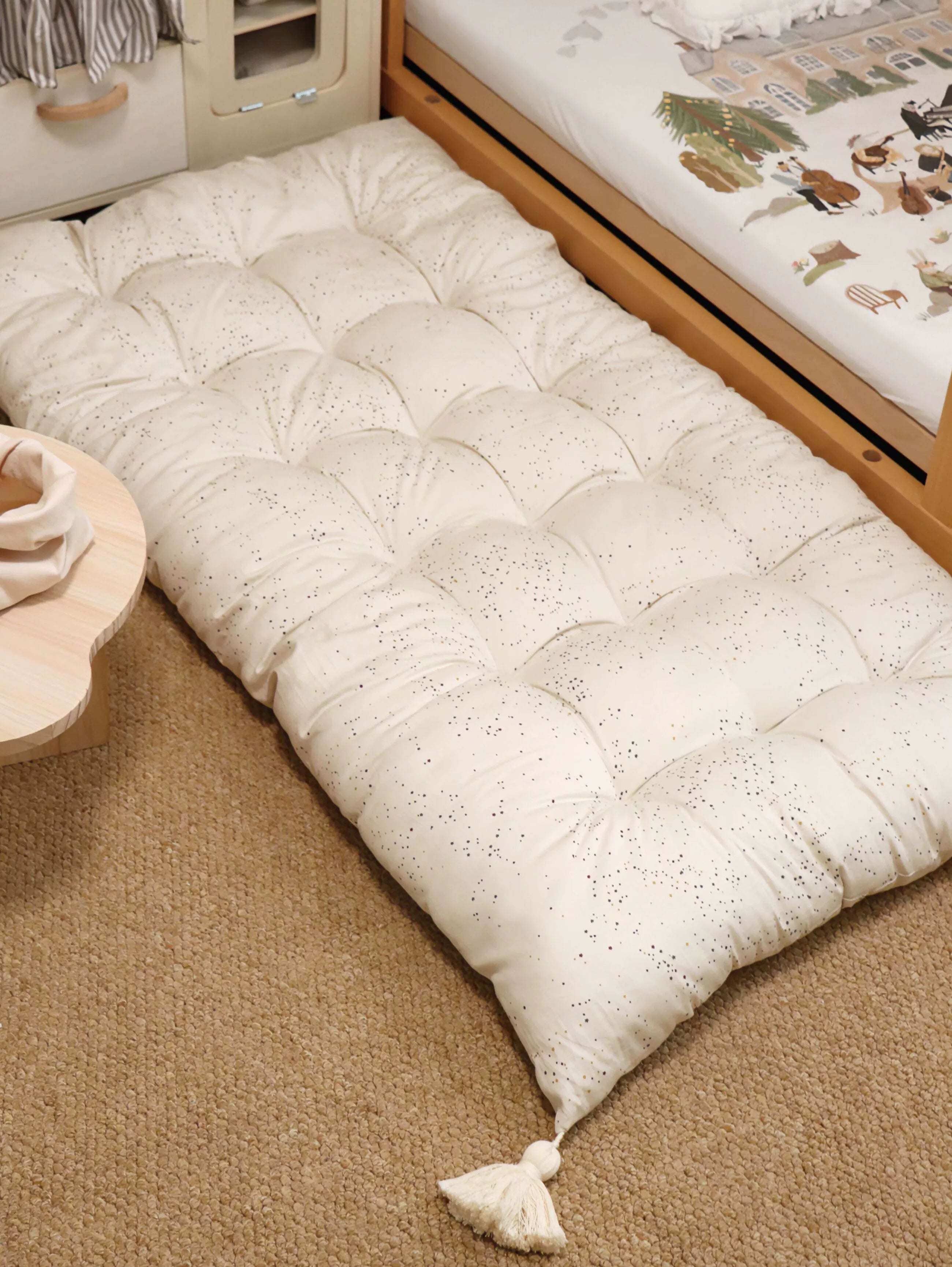 Beige dotted floor cushion with tassels for kids room, play mat, floor seating.