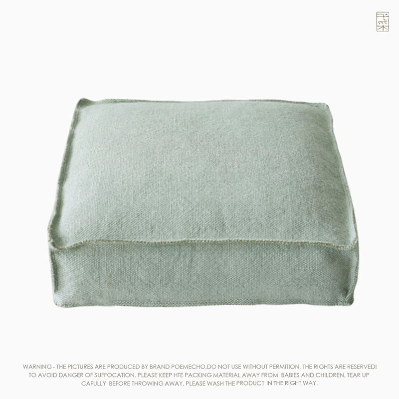 Light sage green square knitted pouf ottoman, featuring a simple, clean design with visible stitching.