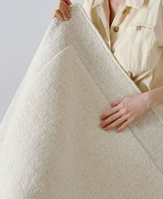 Natural Handwoven New Zealand Wool Rug in cream, showing texture and quality.