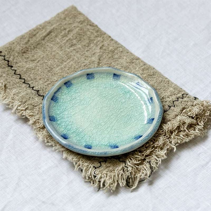 Blue and Teal Crackle Glaze Ceramic Plate Set on rustic linen napkin.