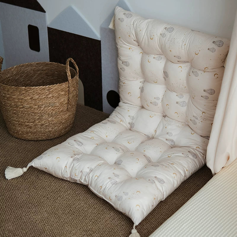 Tufted floor cushion and backrest set with a subtle hot air balloon pattern in a child's play area.