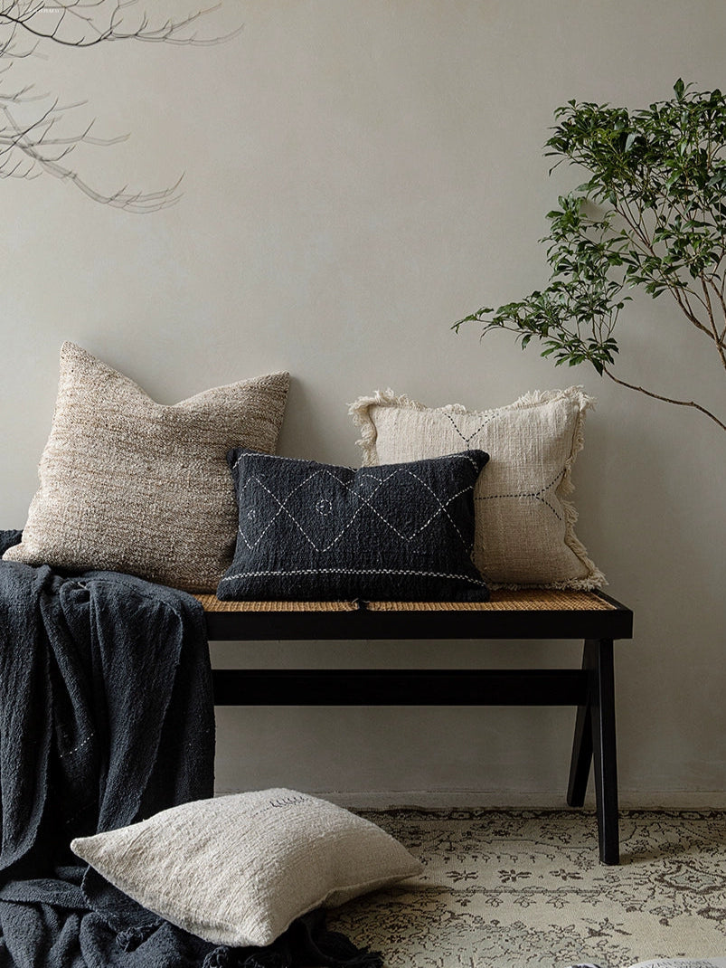 Boho Throw Pillows & Blanket Set: beige, black, natural woven cushions and dark blanket on bench.