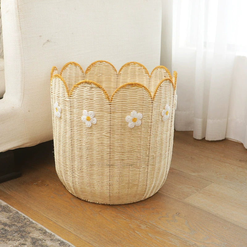 Light beige woven basket with scalloped edge and yellow trim.  White daisy embroidery accents the basket.  Natural rattan material.