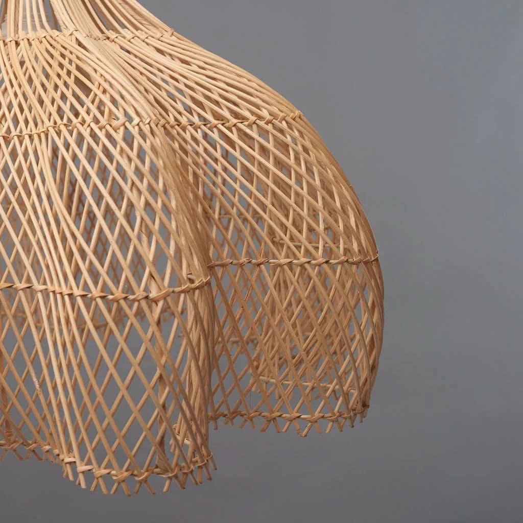 Natural rattan pendant light with a teardrop shape, woven texture, home decor accent.