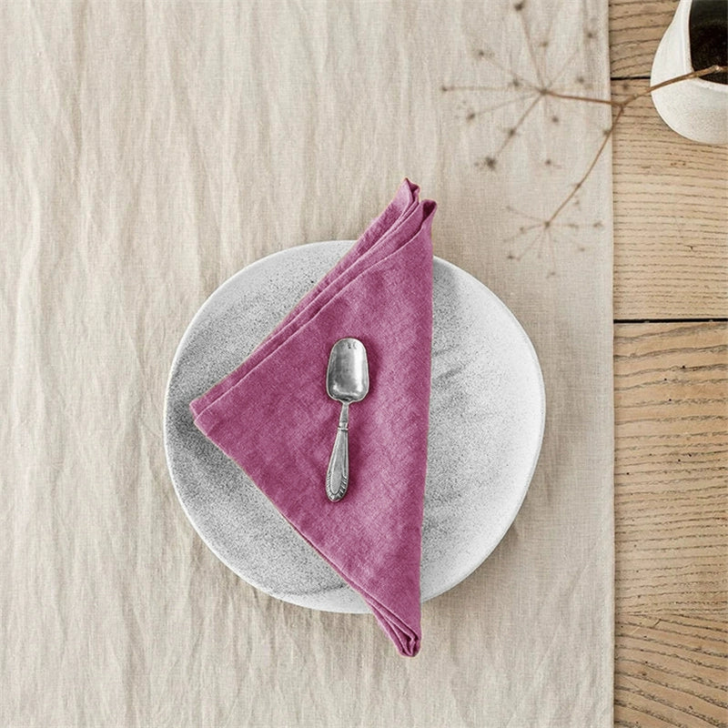 Elegant Linen Table Napkins - Knotted, Berry, Set of 4 on a plate.