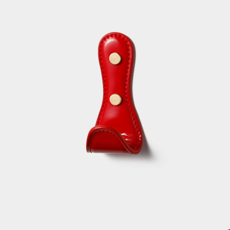 Red shiny leather wall hook with gold accents. Colorful Leather Wall Hooks.