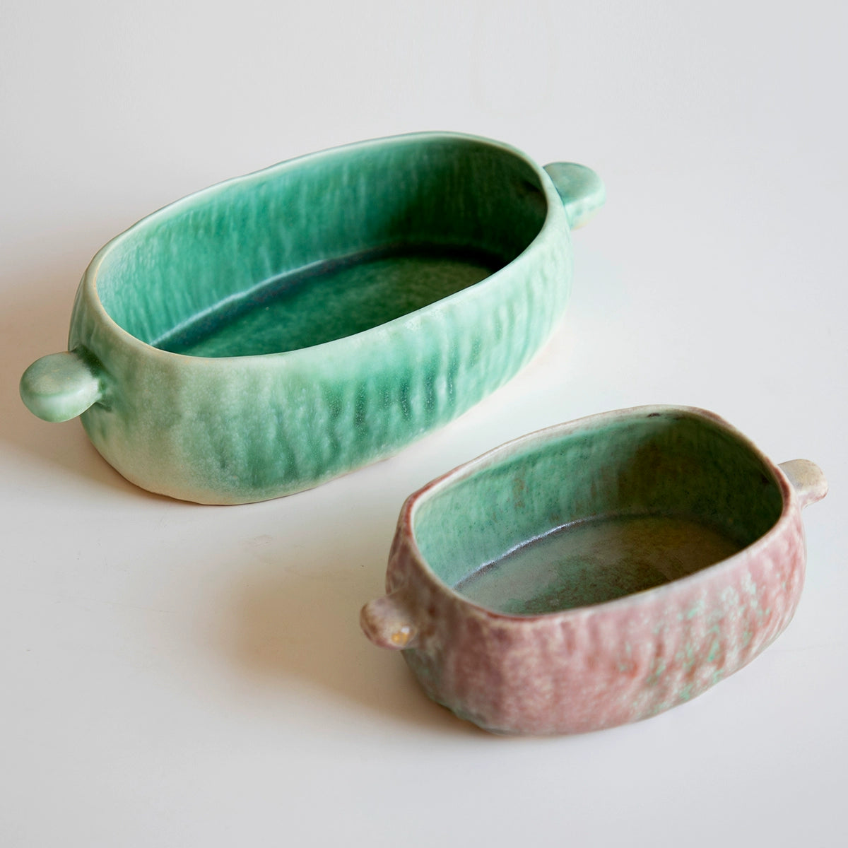 Green & Rose hand-painted ceramic serving dishes, set of 5. Textured, oval dishes on white background.