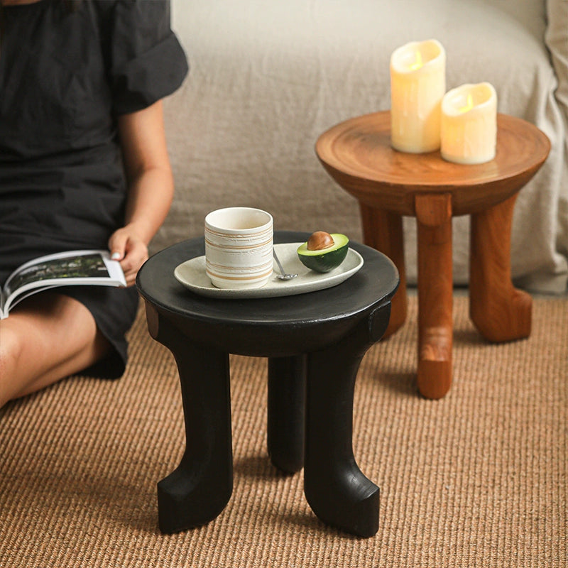 Black Ethnic Style Wooden Side Table with curved legs, holding coffee cup and avocado