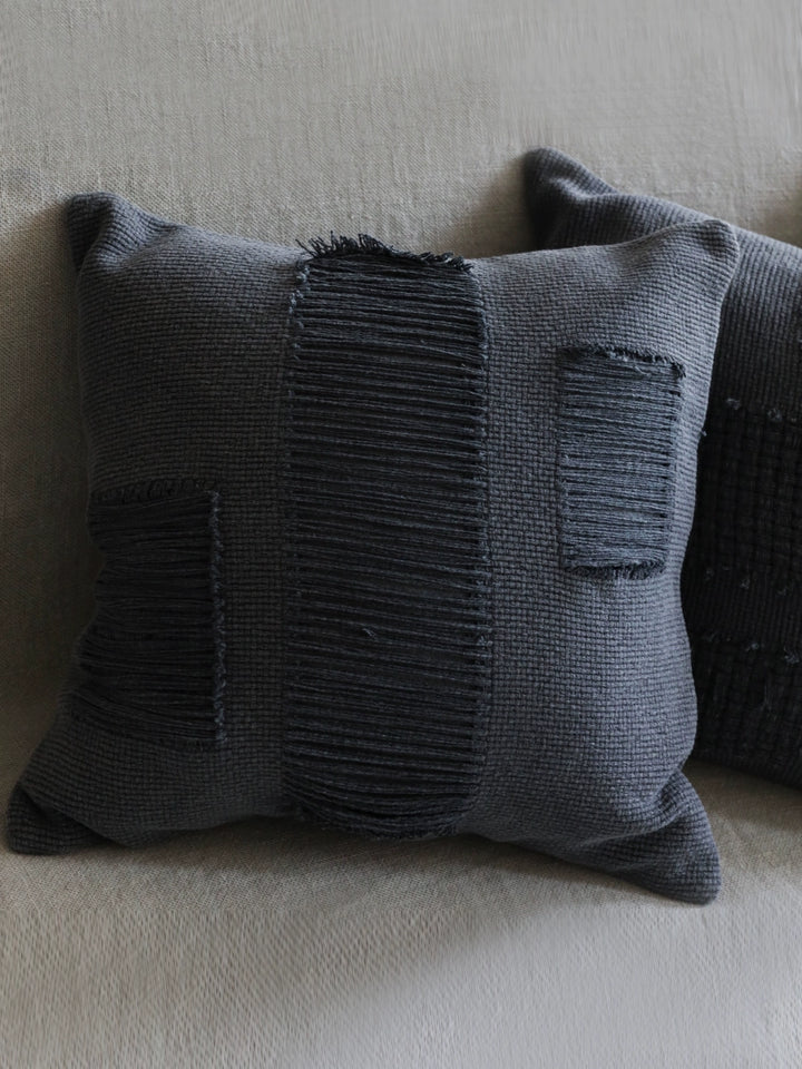 Dark gray woven throw pillows, set of 4, with textured vertical stripes and frayed edges.  Modern boho style.