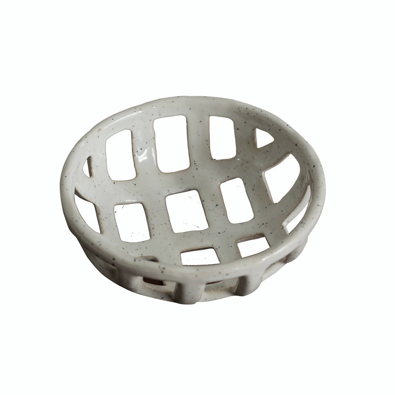 Light beige ceramic fruit bowl with a hollowed-out lattice design.  Handmade, speckled finish.
