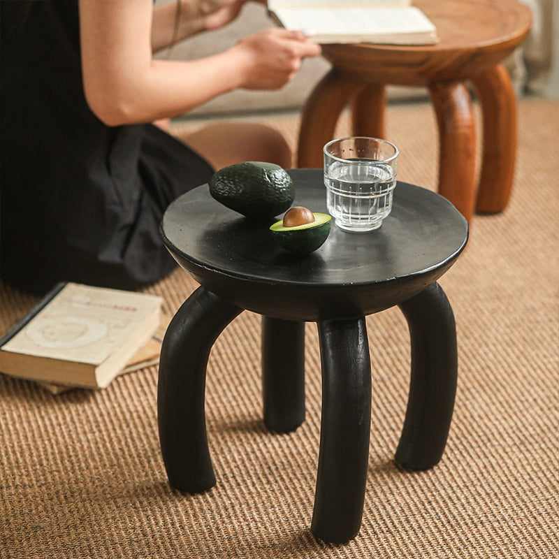 Ethnic Style Wooden Side Table: Round black wood coffee table with curved legs.