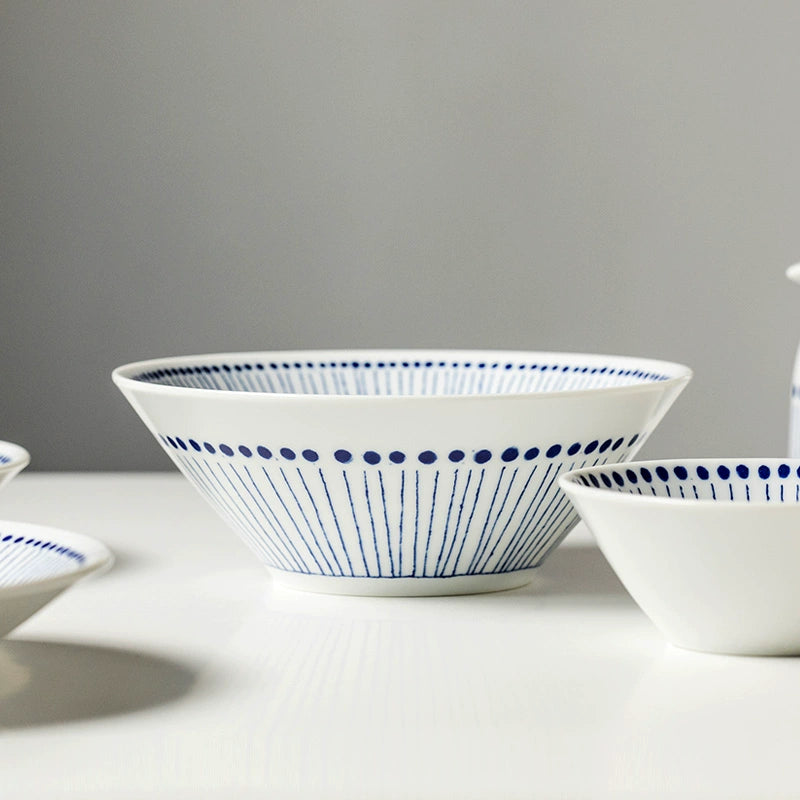 Blue & White Dotted Rim Dinnerware Set: ceramic bowls with blue stripe and dot design.