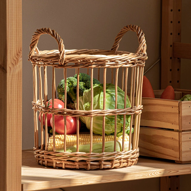 Round woven wicker basket with handles, storing fresh fruits and vegetables.