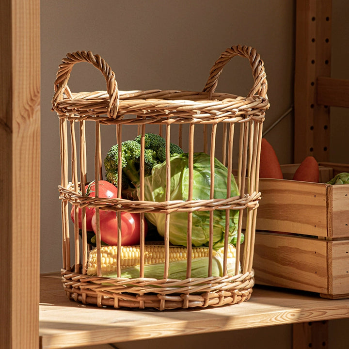 Round woven wicker basket with handles, filled with fruits and vegetables.  Natural rattan.