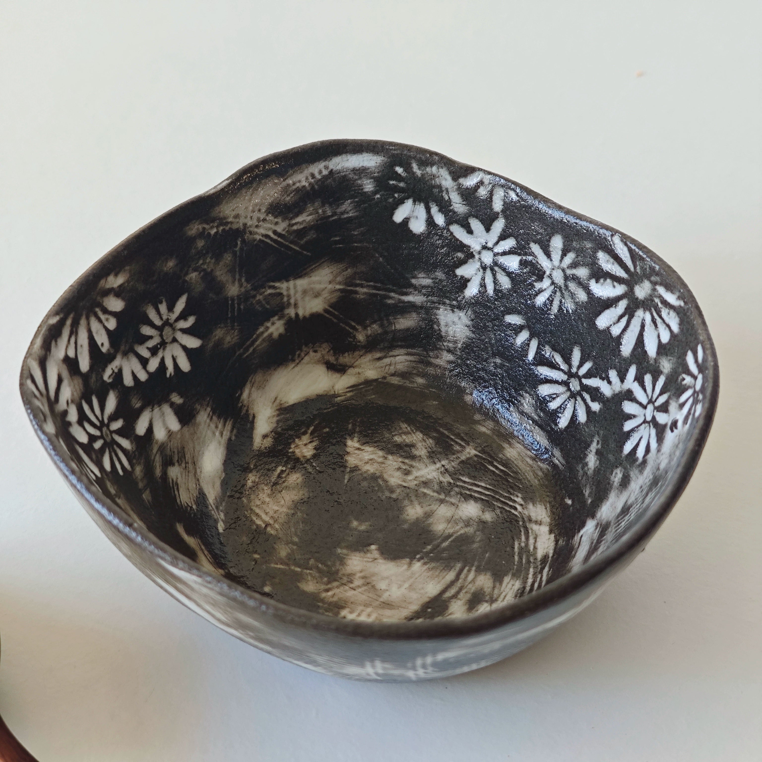 Hand-painted ceramic bowl, black & white floral design, home decor.
