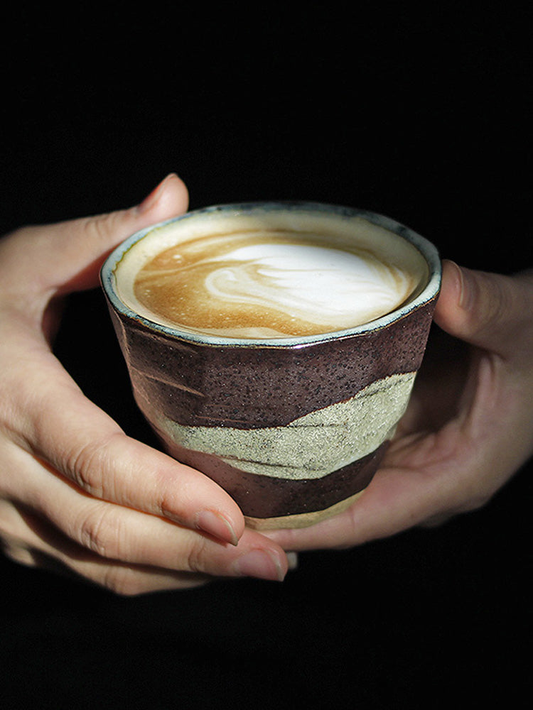 Hand holding Japanese handmade coffee cup