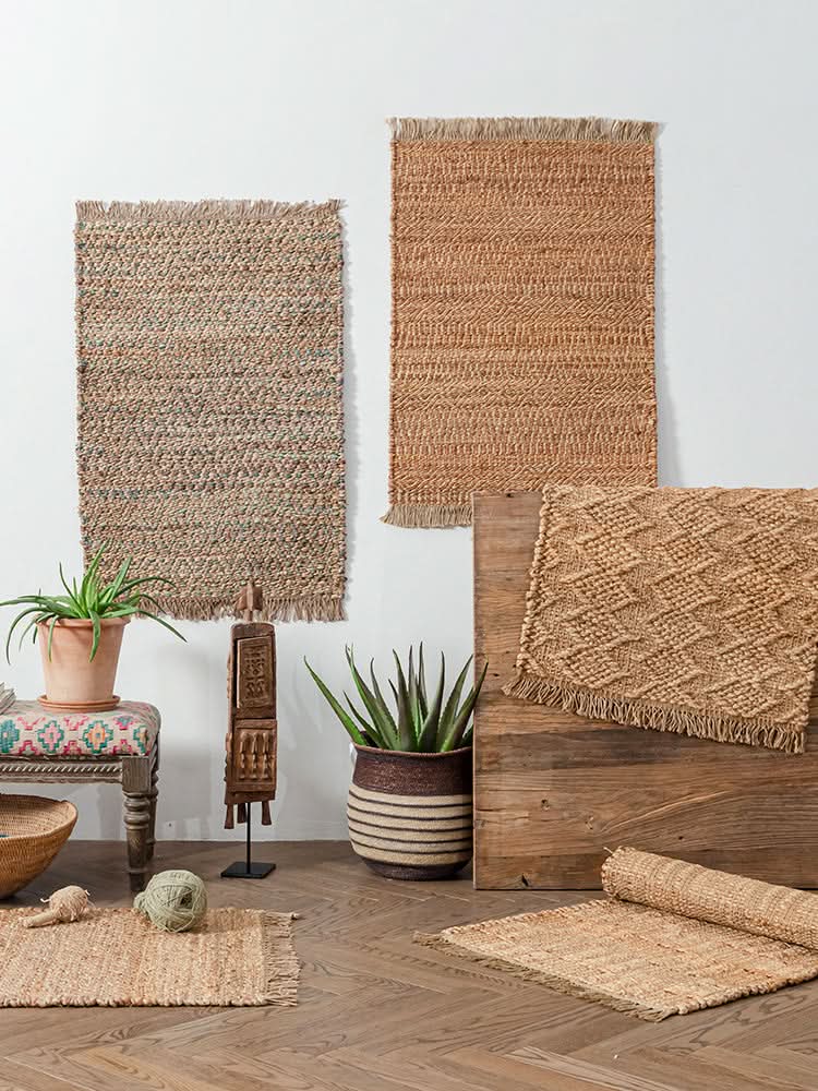 Natural fiber woven area rug in tan and earthy tones with fringed edges.